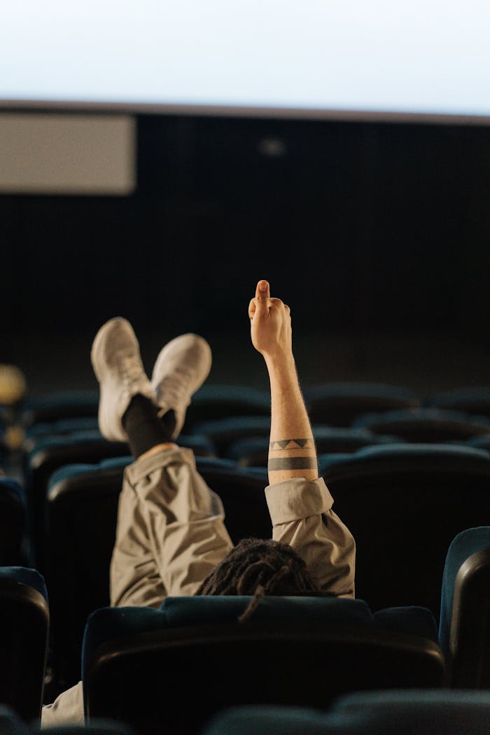 The Art of Drawing Readers In: Your attractive post title goes here Person lounging in an empty cinema, showing a relaxed and intimate movie experience.